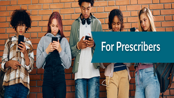 teens standing against a brick wall on their phones