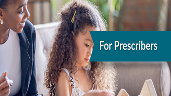 girl focused on a task while sitting next to a therapist