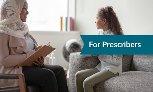 Child sitting on a couch looking out a window