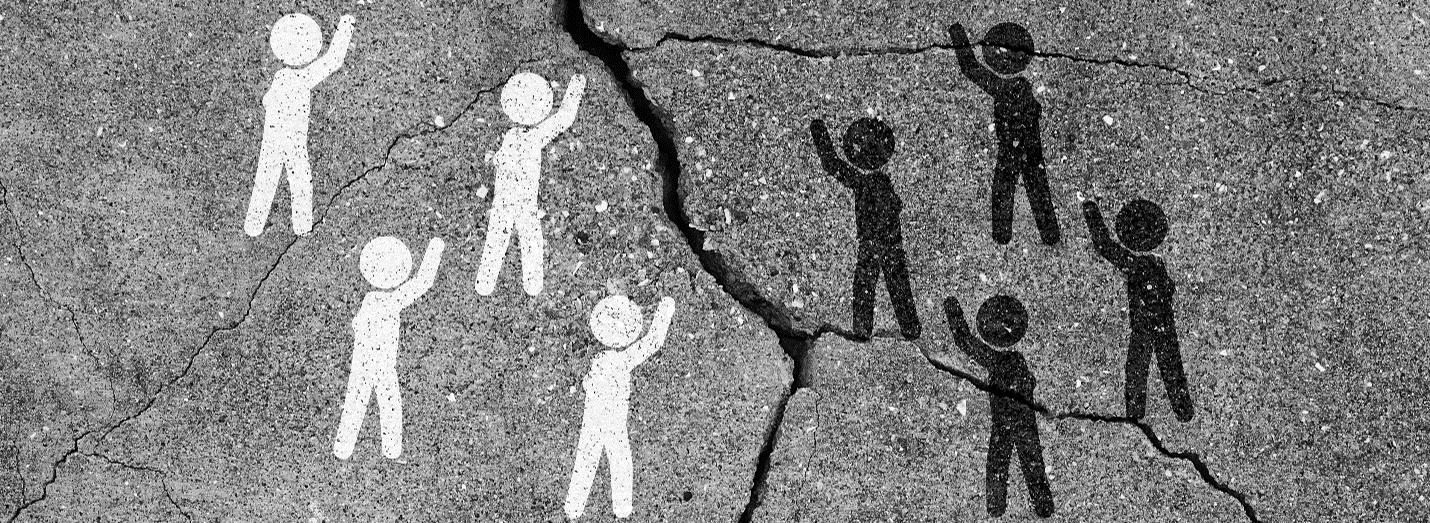 spray painted upon pavement are 4 people icons colored white, a crack in the pavement and on the other side of the crack, 4 person icons colored black. Each person icon had their arm raised in a welcoming fashion.