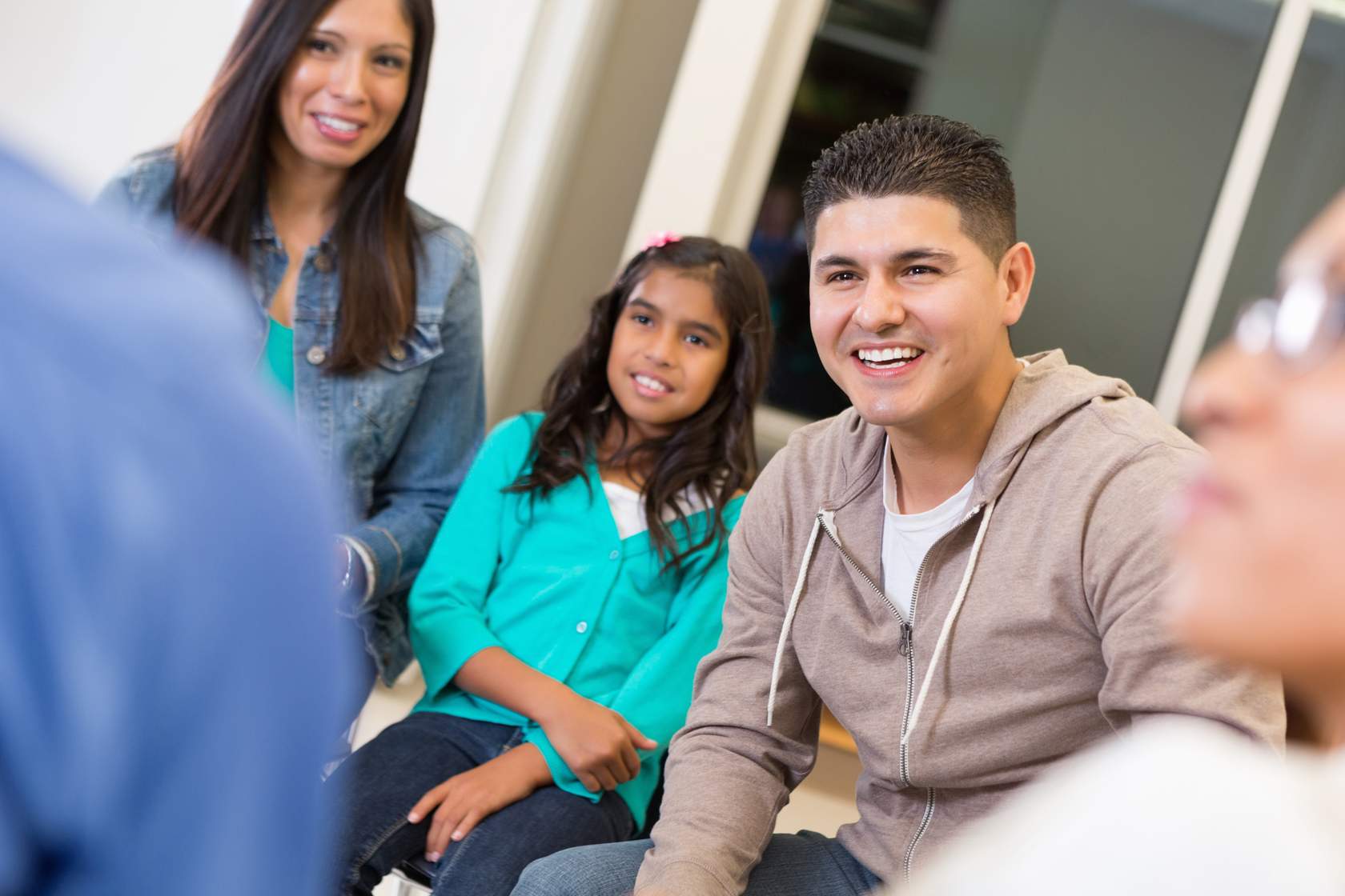 family in living room chatting with each other