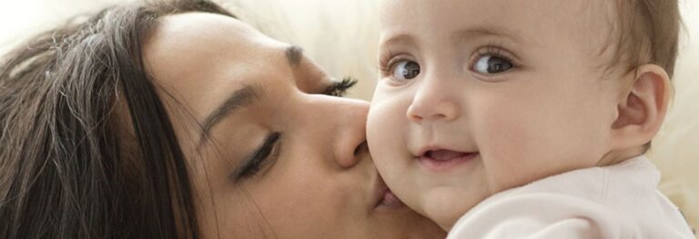 Woman kissing a baby